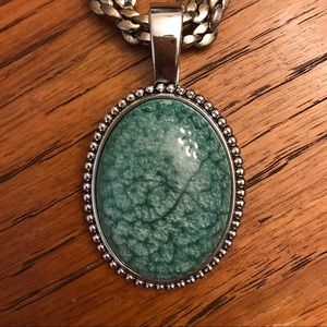 Silver chain with turquoise pendant.